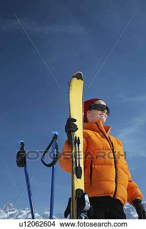 Woman smiling by ski and ski poles View Large Photo Image Picture - Woman smiling by ski and ski poles. Fotosearch