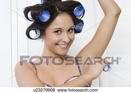 Woman using deodorant View Large Photo Image Stock Photo - Woman using deodorant. Fotosearch