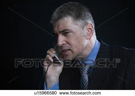 Stock Image - Worried Businessman on the Telephone. Fotosearch