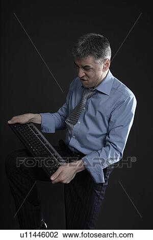 Worried Businessman with a Computer Keyboard View Large Photo Image Stock Image - Worried Businessman with a Computer Keyboard. Fotosearch