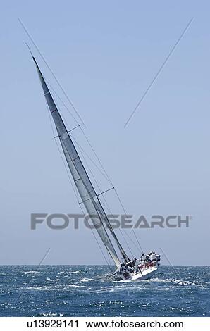 Stock Image - Yacht competes in team sailing event California. Fotosearch