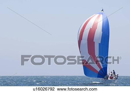 Stock Image - Yacht competes in team sailing event California. Fotosearch