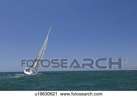 Stock Image - Yacht competes in team sailing event California. Fotosearch