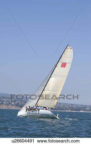 Stock Image - Yacht competes in team sailing event California. Fotosearch