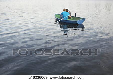 Stock Photo - Young Couple Cuddling in Rowboat on Lake. Fotosearch