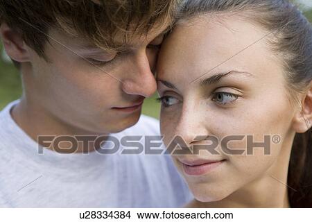 Young couple embracing in orchard View Large Photo Image Picture - Young couple embracing in orchard. Fotosearch