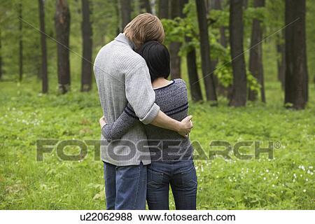Young Couple Hugging in Forest View Large Photo Image Stock Photo - Young Couple Hugging in Forest. Fotosearch