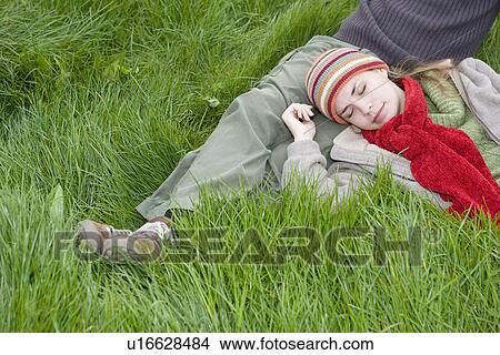 Picture - Young Couple Relaxing in the Grass. Fotosearch
