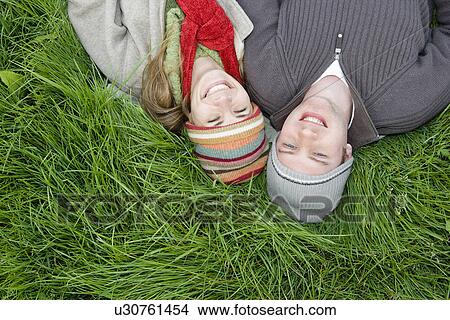 Picture - Young Couple Relaxing in the Grass. Fotosearch