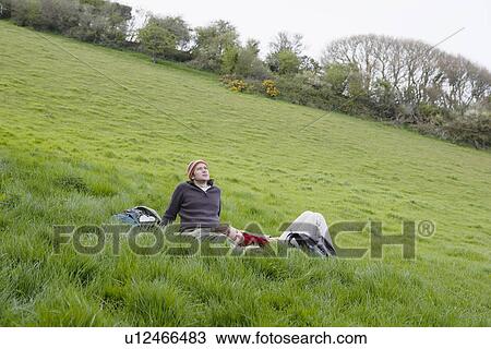 Young Couple Relaxing in the Grass View Large Photo Image Stock Image - Young Couple Relaxing in the Grass. Fotosearch