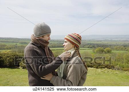 Stock Photography - Young Couple Standing in a Field. Fotosearch