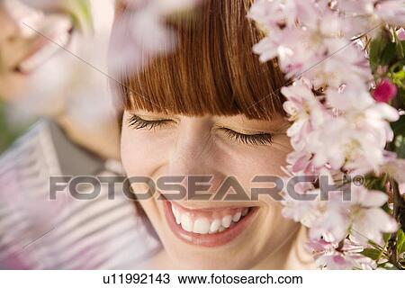 Stock Image - Young Couple Under a Blossoming Tree. Fotosearch