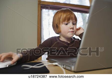 Stock Photo - Young girl (5-6) using laptop. Fotosearch