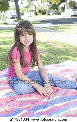 Young girl sitting on picnic blanket View Large Photo Image Picture - Young girl sitting on picnic blanket. Fotosearch
