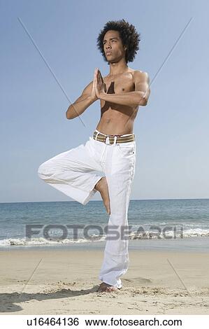 Young man exercising on beach View Large Photo Image Stock Photograph - Young man exercising on beach. Fotosearch