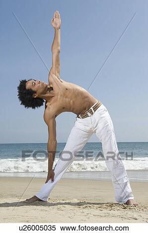 Young man exercising on beach View Large Photo Image Stock Photography - Young man exercising on beach. Fotosearch