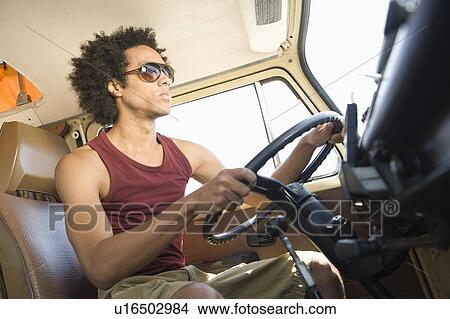 Picture - Young man in camper van. Fotosearch