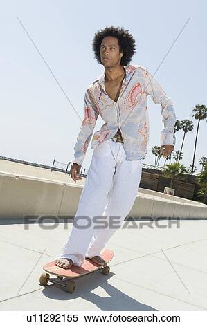 Young man on skateboard View Large Photo Image Stock Photography - Young man on skateboard. Fotosearch