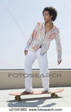 Young man on skateboard View Large Photo Image Stock Photography - Young man on skateboard. Fotosearch