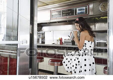 Young Woman Drinking a Milkshake View Large Photo Image Stock Image - Young Woman Drinking a Milkshake. Fotosearch