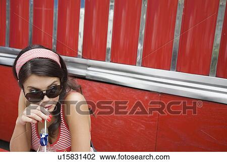 Young Woman Drinking a Soda View Large Photo Image Stock Image - Young Woman Drinking a Soda. Fotosearch