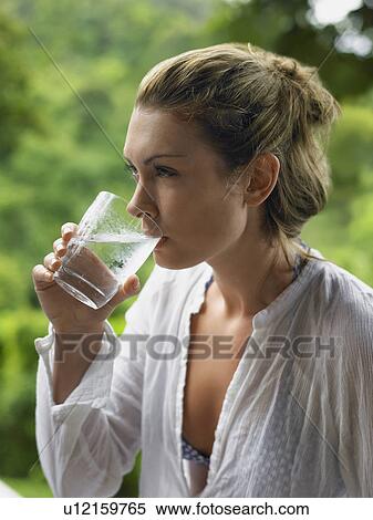 Stock Photography - Young Woman Drinking Water. Fotosearch
