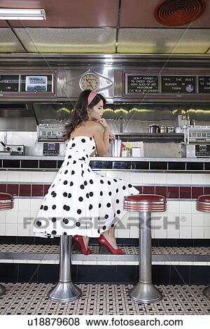 Stock Photo - Young Woman in a Diner. Fotosearch