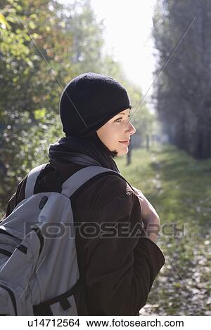 Young woman in winter clothing at park View Large Photo Image Picture - Young woman in winter clothing at park. Fotosearch
