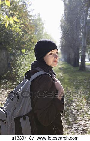 Young woman in winter clothing at park View Large Photo Image Stock Photo - Young woman in winter clothing at park. Fotosearch