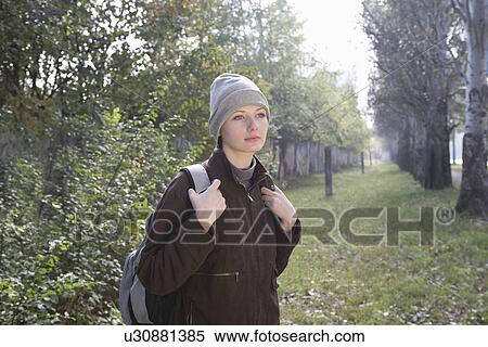 Young woman in winter clothing at park View Large Photo Image Stock Photography - Young woman in winter clothing at park. Fotosearch