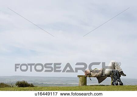 Young Woman Lying on a Park Bench View Large Photo Image Stock Photo - Young Woman Lying on a Park Bench. Fotosearch