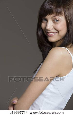 Picture - Young woman posing in tank top. Fotosearch