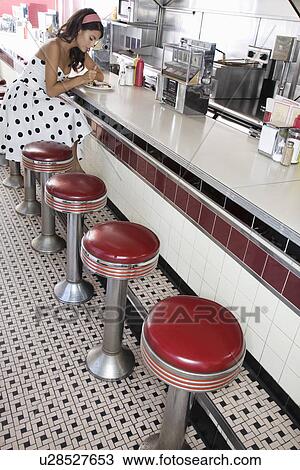 Young Woman Sitting at a Diner Counter View Large Photo Image Stock Image - Young Woman Sitting at a Diner Counter. Fotosearch