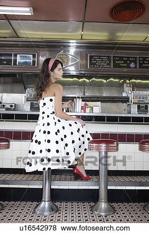 Young Woman Sitting at a Diner Counter View Large Photo Image Stock Photo - Young Woman Sitting at a Diner Counter. Fotosearch