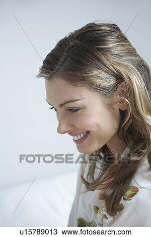 Young woman smiling on bed close-up View Large Photo Image Stock Image - Young woman smiling on bed close-up. Fotosearch