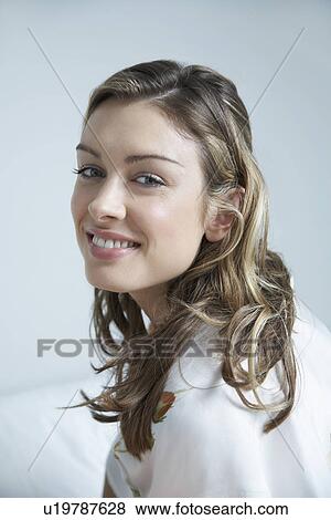 Young woman smiling on bed portrait View Large Photo Image Stock Photo - Young woman smiling on bed portrait. Fotosearch
