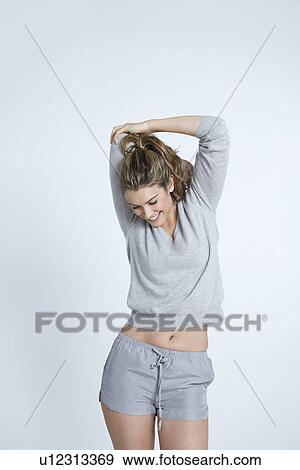 Young woman stretching View Large Photo Image Stock Photo - Young woman stretching. Fotosearch