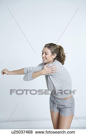 Young woman stretching View Large Photo Image Stock Photo - Young woman stretching. Fotosearch