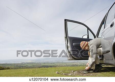 Picture - Young Woman Tying Her Shoe. Fotosearch