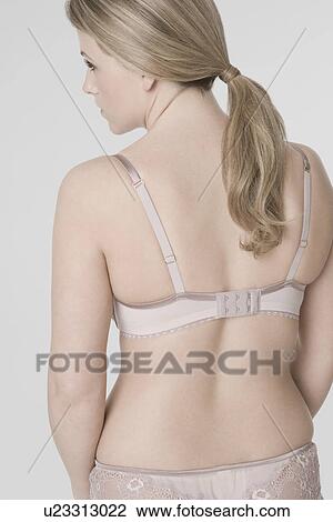 Young woman wearing bra rear view View Large Photo Image Stock Image - Young woman wearing bra rear view. Fotosearch