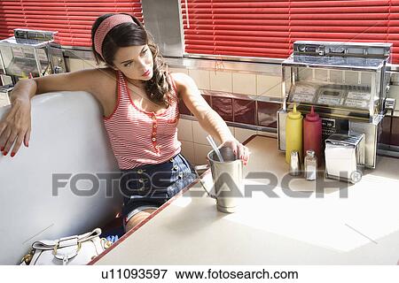 Young Woman Young Woman Relaxing in a Diner Booth?? in a Diner View Large Photo Image Stock Photo - Young Woman Young Woman Relaxing in a Diner Booth?? in a Diner. Fotosearch