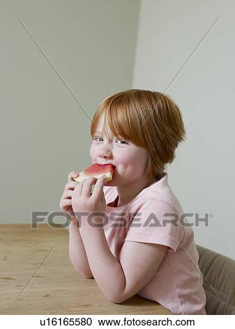 7-8 year old girl smiles as she eats a piece of melon View Large Photo Image Stock Image - 7-8 year old girl smiles as she eats a piece of melon. Fotosearch