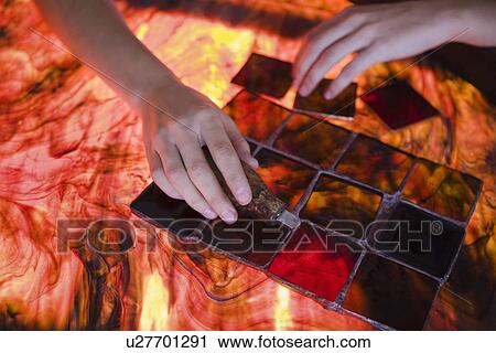 Stock Image - Artist producing textiles close-up. Fotosearch