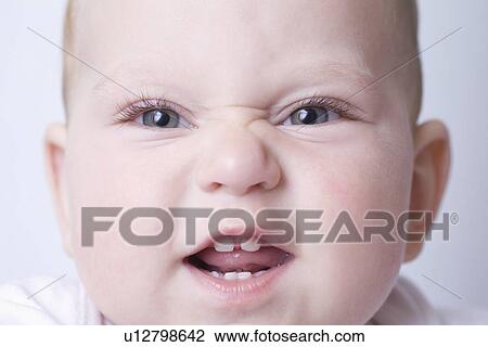 Baby boy pulls funny face with scrunched up nose View Large Photo Image Stock Image - Baby boy pulls funny face with scrunched up nose. Fotosearch