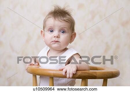 Baby boy sitting on high chair portrait View Large Photo Image Picture - Baby boy sitting on high chair portrait. Fotosearch