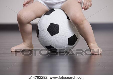 Baby boy sitting on soccer ball View Large Photo Image Stock Image - Baby boy sitting on soccer ball. Fotosearch