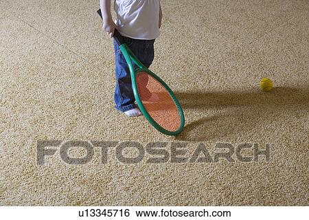 Stock Photograph - Baby girl holding tennis racket. Fotosearch