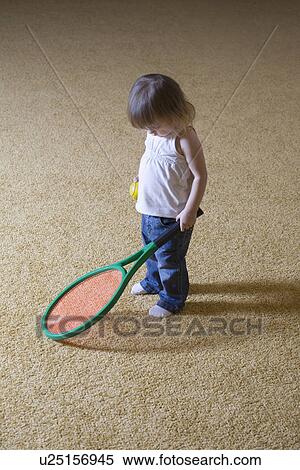 Stock Photography - Baby girl holding tennis racket. Fotosearch