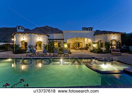 Back yard with illuminated swimming pool dusk View Large Photo Image Stock Photo - Back yard with illuminated swimming pool dusk. Fotosearch