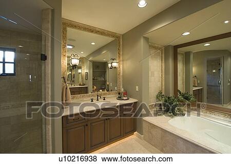Stock Photo - Bathroom with square mirror in Palm Springs home. Fotosearch